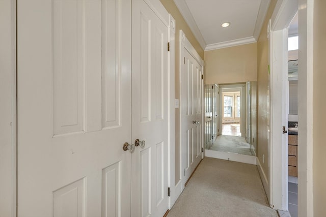 hall featuring crown molding and light colored carpet