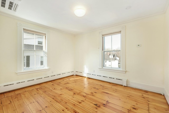 unfurnished room with a baseboard heating unit and light hardwood / wood-style flooring