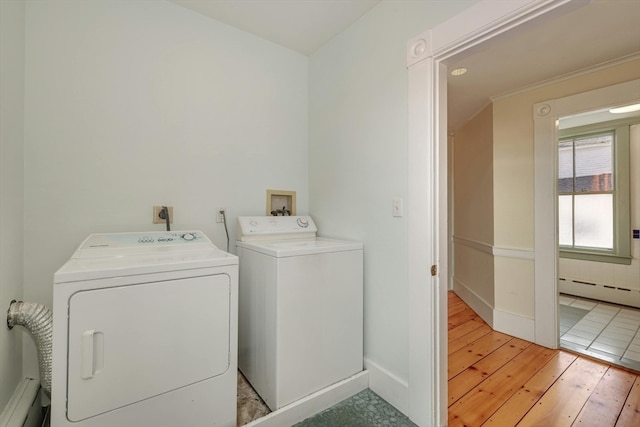 clothes washing area featuring a baseboard heating unit, electric dryer hookup, hookup for a washing machine, washing machine and clothes dryer, and light tile floors