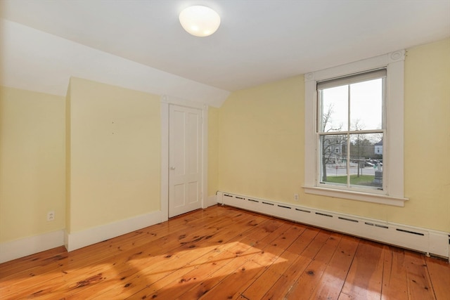 spare room featuring light hardwood / wood-style floors and a baseboard radiator