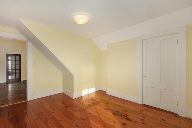 bonus room featuring vaulted ceiling and dark hardwood / wood-style flooring