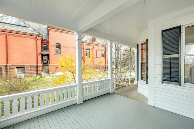 unfurnished sunroom with beam ceiling, ornate columns, and a baseboard heating unit