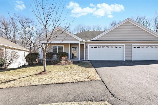 single story home with a garage and driveway