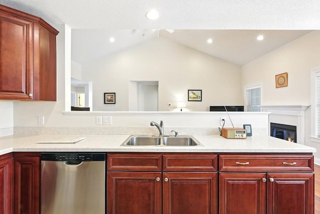 kitchen with dark brown cabinets, dishwasher, light countertops, lofted ceiling, and a sink