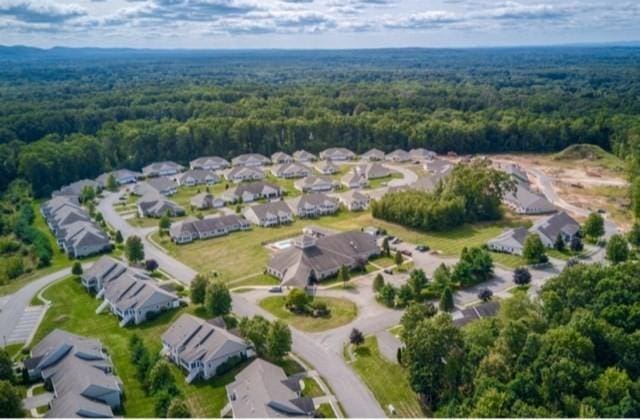 birds eye view of property featuring a wooded view and a residential view