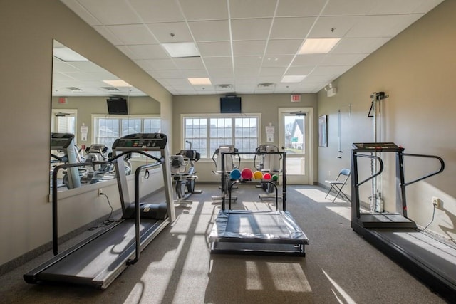 workout area with baseboards and a paneled ceiling