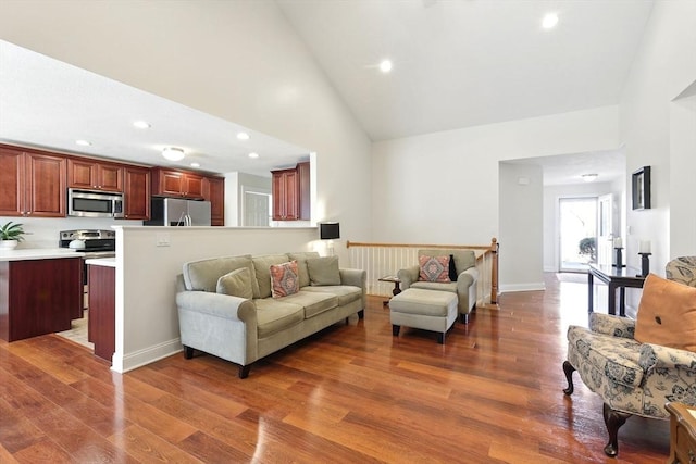 living room with recessed lighting, baseboards, high vaulted ceiling, and wood finished floors