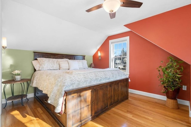 bedroom featuring light hardwood / wood-style flooring, ceiling fan, and vaulted ceiling