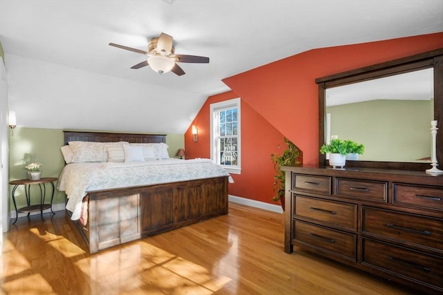 bedroom with vaulted ceiling and light wood-type flooring