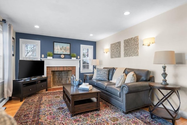 living room featuring wood-type flooring and a fireplace