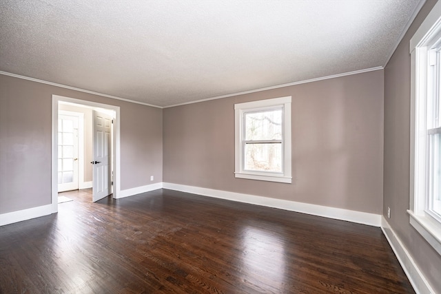 empty room featuring ornamental molding, dark wood-type flooring, and a textured ceiling