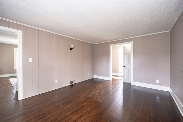 unfurnished room featuring dark wood-type flooring, crown molding, and a textured ceiling