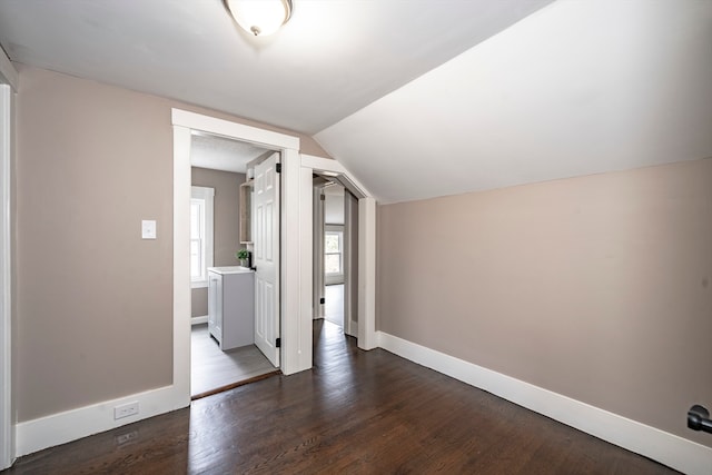 bonus room featuring vaulted ceiling and dark hardwood / wood-style flooring