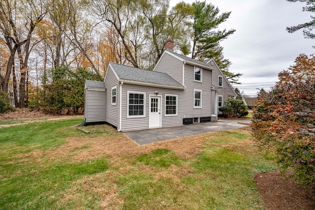 rear view of house featuring a patio and a lawn