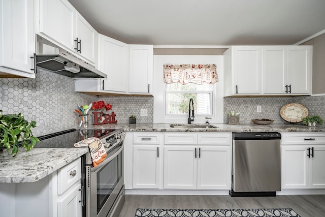 kitchen featuring backsplash, stainless steel appliances, sink, and white cabinets