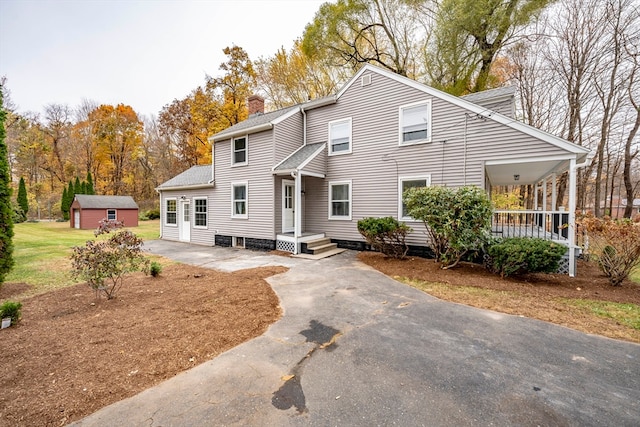 view of front property with an outbuilding and a porch