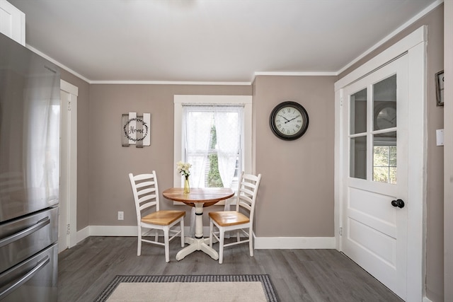 dining room with dark hardwood / wood-style flooring, ornamental molding, and plenty of natural light