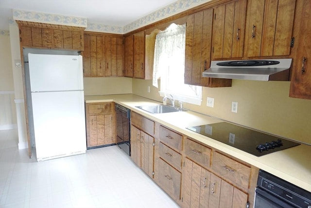40 Miriam Ln, Lowell, MA 01852 - kitchen with black appliances, under cabinet range hood, brown cabinets, and light countertops