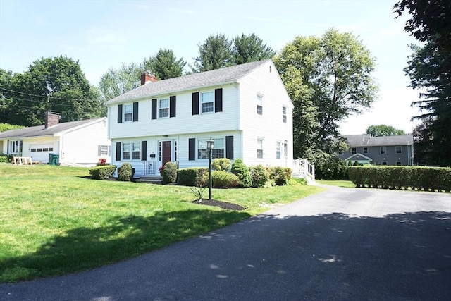40 Miriam Ln, Lowell, MA 01852 - colonial inspired home with a chimney, a front yard, and asphalt driveway