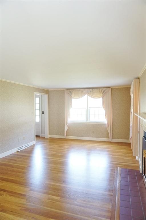 40 Miriam Ln, Lowell, MA 01852 - unfurnished living room featuring wood finished floors, ornamental molding, a fireplace, and wallpapered walls