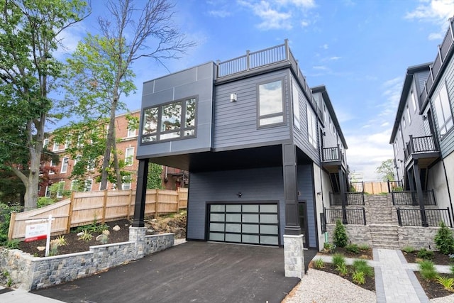 33 Evergreen St Unit 2, Boston, MA 02130 - contemporary home featuring an attached garage, asphalt driveway, and a balcony