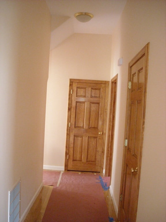 hallway with carpet floors