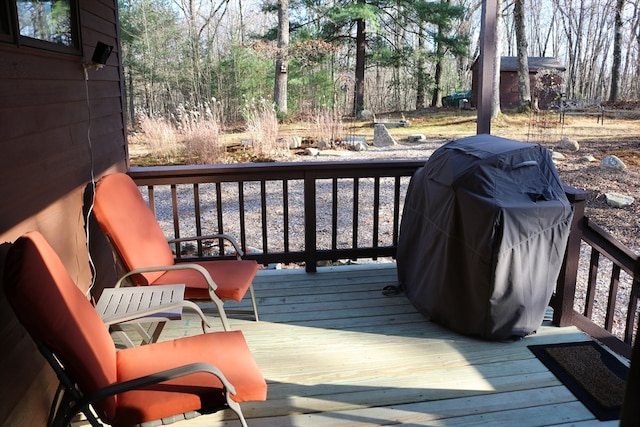 wooden terrace featuring a grill