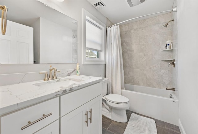 full bath with visible vents, vanity, toilet, and shower / bath combo with shower curtain