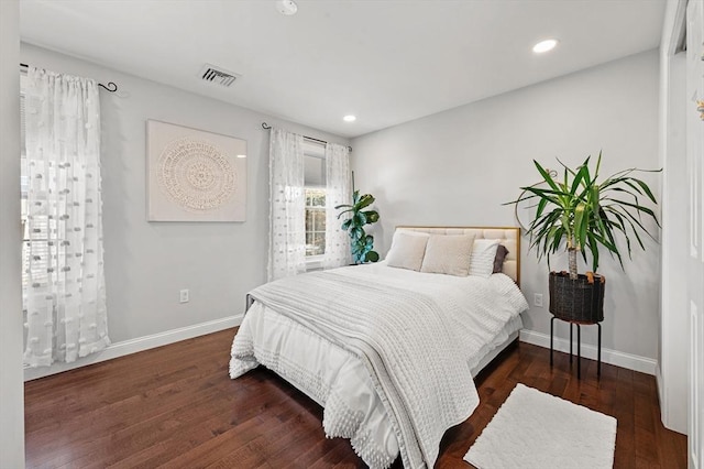 bedroom featuring recessed lighting, wood finished floors, visible vents, and baseboards