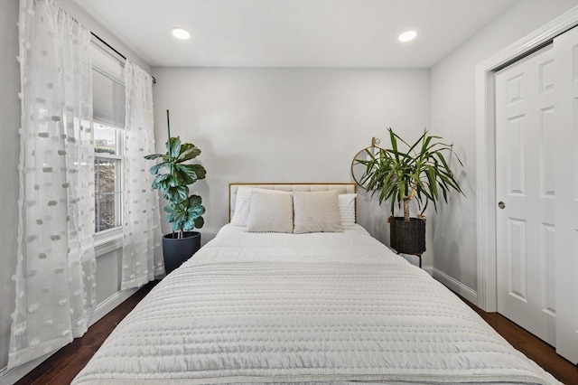 bedroom featuring dark wood finished floors, recessed lighting, and baseboards