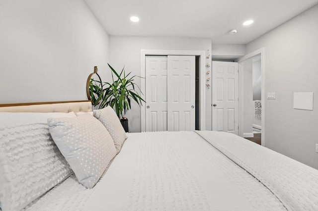 bedroom with recessed lighting and a closet