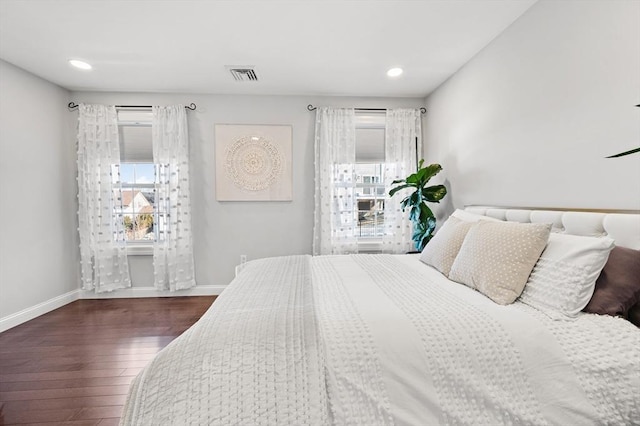 bedroom with recessed lighting, visible vents, baseboards, and dark wood-type flooring