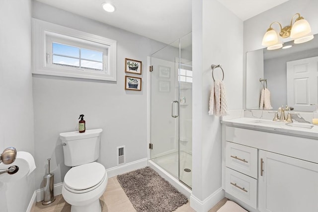 full bathroom featuring vanity, toilet, visible vents, and a stall shower