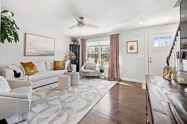 living area featuring wood finished floors, baseboards, a ceiling fan, recessed lighting, and stairs