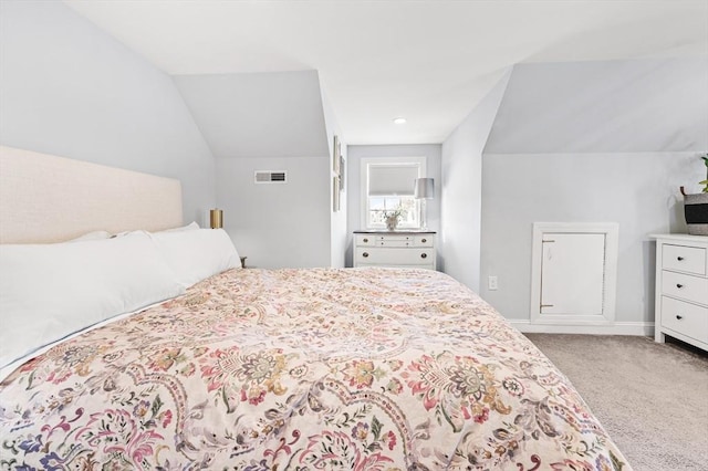 bedroom featuring lofted ceiling, baseboards, visible vents, and carpet floors