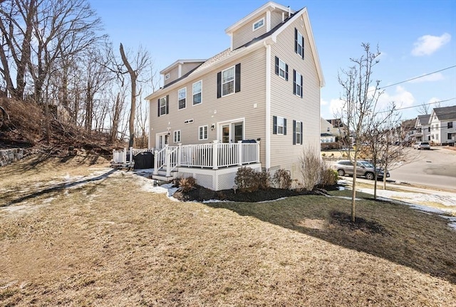 exterior space featuring a wooden deck and a yard