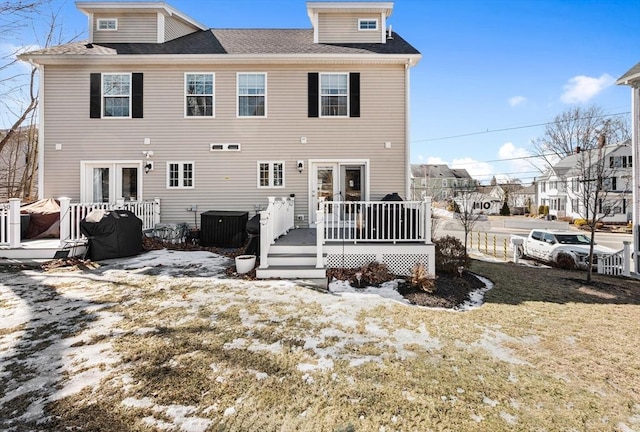 rear view of property featuring cooling unit, french doors, and a wooden deck