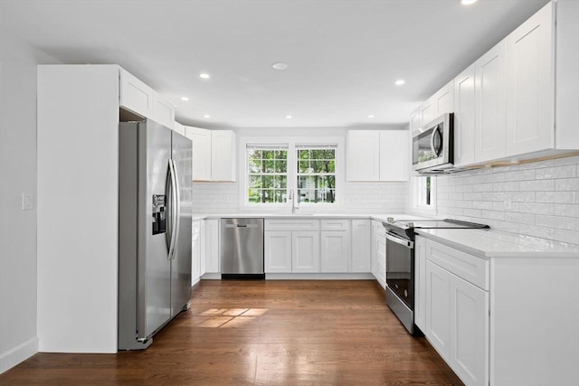 125 Beacon St, Framingham, MA 01701 - kitchen featuring stainless steel appliances, dark wood-style flooring, recessed lighting, decorative backsplash, and white cabinetry