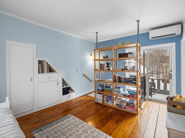 living room with crown molding, a wall mounted air conditioner, and light wood-type flooring