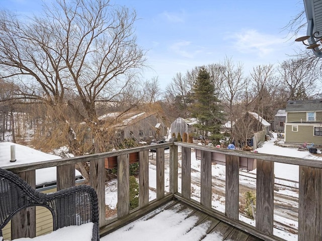 view of snow covered back of property