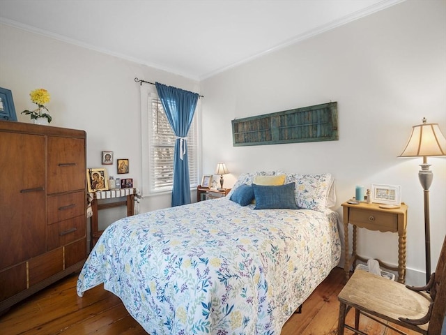 bedroom featuring dark hardwood / wood-style flooring and crown molding