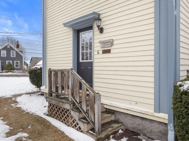 view of snow covered property entrance