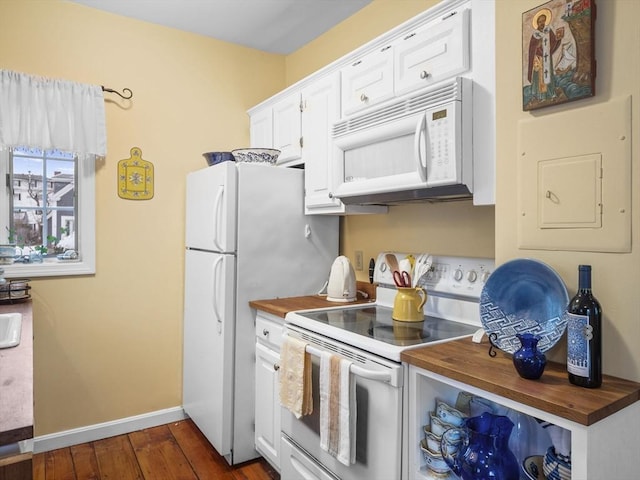 kitchen featuring butcher block counters, white appliances, and white cabinetry