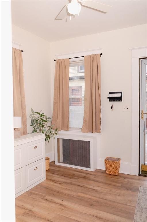 mudroom with light hardwood / wood-style floors, ceiling fan, and radiator heating unit