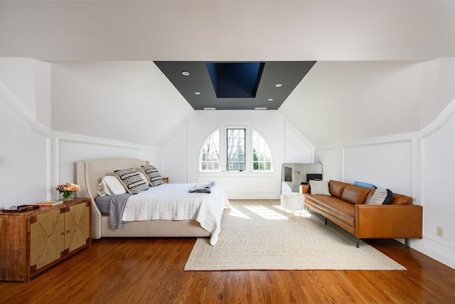 bedroom featuring lofted ceiling and wood-type flooring