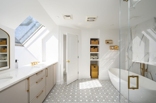 full bathroom featuring vanity, toilet, a skylight, and separate shower and tub