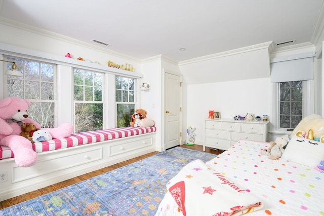 bedroom featuring crown molding and dark hardwood / wood-style flooring