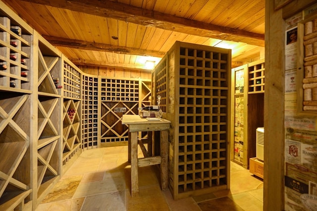 wine area featuring beamed ceiling and wooden ceiling