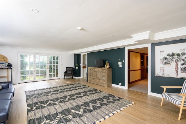 living room featuring hardwood / wood-style floors and crown molding