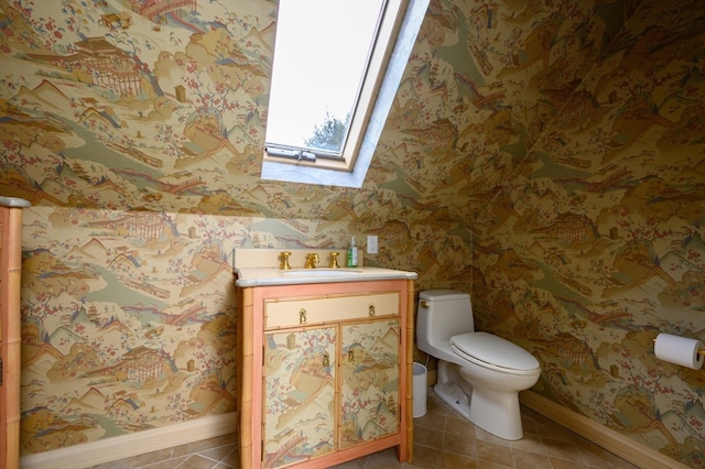 bathroom with vanity, toilet, and tile patterned flooring